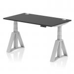 The photograph showcases a sleek black top desk with silver legs, equipped with cable ports and a piste foot for support. The desk is dynamic and can easily transition from sit to stand, with a size of 1400 x 800mm for optimal workspace. Perfect for any modern office setting.