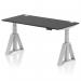 This photo features a sleek and modern Dynamic Sit Stand and Height Adjustable Desk, measuring 1600 x 800mm and equipped with cable ports. The desk has a black top and silver legs, as well as a Piste Foot for added support.