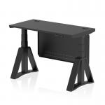 The photograph shows a sleek and modern Dynamic Sit Stand and Height Adjustable Desk. The desk features a 1200 x 600mm black top with cable ports, black legs, and a black steel modesty panel. The piste foot provides stability while working.