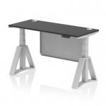 The photograph captures a sleek and modern office workspace with a dynamic sit stand and height adjustable desk. The desk features a black top with cable ports and a silver leg, complemented by a silver steel modesty panel and piste foot. The 1400 x 600mm desk is versatile and practical for any work environment.
