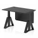 The photograph shows a sleek and modern office desk with a black top and matching black steel modesty panel. The desk is equipped with cable ports and a piste foot for stability. It is also height adjustable, allowing for both sitting and standing work. Perfect for a dynamic and ergonomic workspace.