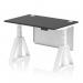 The image shows a sleek and modern office desk with a black top and white legs. The desk is 1200 x 800mm in size and has cable ports for organization. It features a dynamic sit-stand function and can be easily adjusted to various heights. A white steel modesty panel adds a touch of elegance, and the piste foot provides stability. This desk is perfect for any professional workspace.