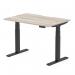 This photo shows a modern and versatile office desk, measuring 1200 x 800mm, with a scalloped edge for added style. The height adjustable feature allows for a dynamic sit-stand option, promoting a healthier work environment. The grey oak top and black leg give a sleek and professional look to any workspace.