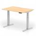 This photo captures a modern and versatile workspace, with a dynamic sit stand and height adjustable desk. The desk features a 1200 x 800mm maple top with a scalloped edge, paired with sleek silver legs. Perfect for any office setting looking for a functional and stylish desk option.