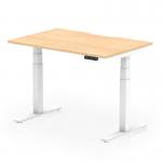 The photograph captures a modern office space with dynamic sit stand and height adjustable desks. The desks have a sleek maple top and white legs, with a scalloped edge for added style. The space is well-lit and organized, creating a productive atmosphere.