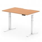 The photo showcases a sleek and modern Dynamic Sit Stand and Height Adjustable Desk. The desk features a 1200 x 800mm oak top with a scalloped edge, paired with a white leg for a minimalist look. Its height can be easily adjusted to suit any individuals needs.