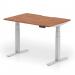 This picture shows a sleek and modern dynamic sit-stand desk with a scalloped edge, measuring 1200 x 800mm. The desk has a walnut top and silver legs, giving it a professional and stylish look. It is height adjustable, allowing for a dynamic work environment.