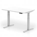 The photograph shows a sleek and modern dynamic sit stand desk, measuring 1200 x 800mm, with a scalloped edge and a white top. The silver leg adds a touch of sophistication to this height adjustable office desk.