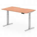 This photo features a sleek and modern Dynamic Sit Stand and Height Adjustable Desk. The desk has a scalloped edge and measures 1400 x 800mm, with a stylish beech top and silver legs. Perfect for any office space.