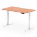 The photograph shows a dynamic sit stand and height adjustable desk, measuring 1400 x 800mm. It features a scalloped edge and a beech top with white legs. The desk is in a modern office setting, with natural light and green plants in the background. The desk can be seen in both sitting and standing positions, and the height adjustment mechanism is clearly visible.