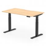 The photograph shows a sleek and modern office desk with a dynamic sit stand feature, with a scalloped edge and a maple top. It is supported by black adjustable legs and has a spacious work surface of 1400 x 800mm. The design promotes a versatile and ergonomic work environment.