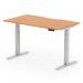 This photograph features a sleek and modern office desk with a scalloped edge oak top and silver adjustable legs. The desks size is 1400x800mm and it offers dynamic sit-stand and height adjustability for maximum comfort and productivity.