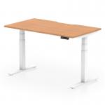 This image features a sleek and modern office desk with a scalloped edge. The desk is made of oak and has a white adjustable leg. The design allows for both sitting and standing options, making it a versatile and ergonomic choice for any workspace.