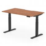 The image shows a sleek, modern office desk with a scalloped edge walnut top and black adjustable legs. Its dynamic design allows for sit-stand and height adjustment, making it versatile and ergonomic for any workspace.