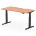 The photograph depicts a sleek and modern dynamic sit stand and height adjustable desk. The desk is 1600 x 800mm in size with a scalloped edge and is made of beech top with black legs. It exudes a professional and functional aesthetic, perfect for any office space.