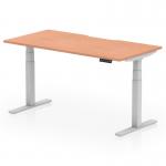 This picture shows a modern and versatile office desk with a scalloped edge, measuring 1600 x 800mm. Its sleek design features an adjustable height system and standing functionality, making it perfect for a dynamic and ergonomic workspace. The light beech top and silver leg add a touch of elegance to any office setting.