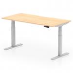 The photo shows a dynamic sit-stand desk with a scalloped edge and a maple top, supported by silver legs. The desk measures 1600 x 800mm and is height adjustable, making it suitable for use in any office setting.
