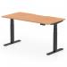 The picture shows a versatile work desk with a scalloped edge, perfect for a modern office. The oak top complements the sleek black leg, and the desk is fully adjustable for standing or sitting.