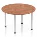 The image features a sleek and modern Dynamic Round Tables Impulse 1200mm Round Table with a rich Walnut top and Silver post leg. The table exudes a sense of efficiency and sophistication, perfect for any workspace or social setting.