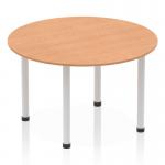 The photograph shows a modern Dynamic Round Tables Impulse 1200mm round table. The table features an oak top and silver post leg, creating a sleek and stylish look. Perfect for any office or meeting space.