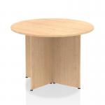 The picture captures a modern round table with a maple top and arrowhead leg design. Its dynamic shape and bold lines make it a striking addition to any space.