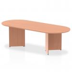 In this image, we see a sleek and modern boardroom with an Impulse 2400mm beech top table at the center. The arrowhead-shaped legs add a touch of sophistication to the dynamic environment. Surrounding the table are conference chairs, creating a professional and collaborative space.