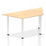 The image features a modern office table with a trapezium maple top and sleek chrome post legs, giving off a dynamic and functional vibe. The 1600mm size provides ample space for work or meetings. This stylish piece is perfect for any professional environment.