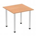 The photograph captures a contemporary and stylish Impulse 800mm square table with an oak top and brushed aluminum post legs. The dynamic design is sleek and sophisticated, making it a perfect addition to any modern workspace or dining area.