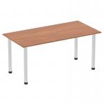 The photograph features a sleek, modern Dynamic Tables Impulse 1600mm straight table with a stunning walnut top and brushed aluminum post legs. Its contemporary design adds a touch of elegance to any office or meeting space.