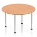 This picture features a 1200mm round table with an oak top and a brushed aluminium post leg. The dynamic design of the table brings a modern touch to any space. The warm tones of the oak top and the sleek finish of the aluminium leg make it a stylish addition to any room.