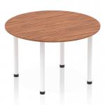 This photo captures an elegant Dynamic Round Tables Impulse 1200mm Round Table in rich walnut with sleek white post legs, creating a modern and dynamic look for any space. The round shape adds a welcoming touch while the contrasting colors make a bold statement.