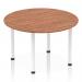 This photo captures an elegant Dynamic Round Tables Impulse 1200mm Round Table in rich walnut with sleek white post legs, creating a modern and dynamic look for any space. The round shape adds a welcoming touch while the contrasting colors make a bold statement.
