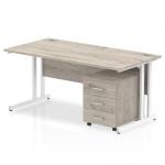 In this photo, you can see a sleek and modern office desk from our Dynamic Furniture Packages range. The desk features a grey oak top and white cantilever legs, giving it a contemporary look. Accompanying the desk is a 3-drawer mobile pedestal, adding both style and functionality to your workspace.