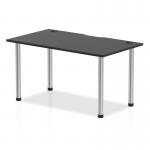 This photograph features a sleek and modern Dynamic Tables Impulse Black Series 1400 x 800mm straight table with a glossy black top and chrome legs. The table also includes built-in cable ports for convenient wire management.
