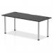 This photograph shows a sleek and modern Dynamic Tables Impulse Black Series 1800 x 800mm Straight Table. The black top is contrasted by a shiny chrome leg and features built-in cable ports for added functionality.