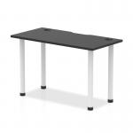 In this photo, the Dynamic Tables Impulse Black Series table is shown with a sleek black top and white legs. The 1200 x 600mm straight design allows for versatile placement in any space. Cable ports are visible for easy wire management.