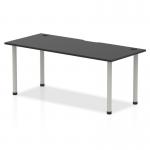 This picture shows a sleek and modern Dynamic Tables Impulse Black Series 1800 x 800mm Straight Table. The black table top is complemented by silver legs and features convenient cable ports for organization. It exudes a professional and stylish impression.