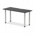This photograph captures a sleek and modern Dynamic Tables Impulse Black Series 1400 x 600mm Straight Table. The black top is contrasted by a silver leg and features convenient cable ports. It exudes a professional and functional aesthetic.
