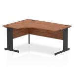 This image features a sleek, modern Dynamic Left Hand Desks Impulse office desk. It measures 1600mm and has a unique left crescent design. The desk has a beautiful walnut top and is supported by a black cable managed leg.