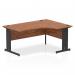 The picture displayed showcases a sleek and modern Dynamic Right Hand Desks Impulse 1600mm Right Crescent Office Desk. The desk features a beautiful walnut top and a black cable managed leg for a clean and organized workspace.
