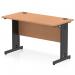 This photograph features a sleek, modern office desk with an oak top and black cable managed legs. The desk measures 1200 x 600mm and is designed for dynamic cable management.