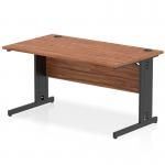 This photograph features a dynamic cable managed desk from the Impulse collection. The desk is 1400 x 800mm and has a sleek walnut top with a black cable managed leg.