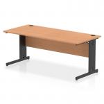 This photo features a sleek and modern Dynamic Cable Managed Desk. The desk measures 1800 x 800mm and has a straight oak top with a black cable managed leg. Perfect for keeping your workspace organized and clutter-free.