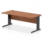 This photograph features a sleek and modern Dynamic Cable Managed Desk with a walnut top and black cable managed legs. The desk measures 1800 x 800mm and has a straight design. The cable management system helps keep wires organized and out of sight. Its a professional and functional addition to any office space.