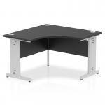 This image features a sleek, modern corner desk with a black top and silver cable managed legs. The desk is part of the Impulse 1200mm series and offers dynamic functionality for an efficient office space.