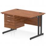 This photograph features a sleek Dynamic Pedestal Desk Impulse with a walnut top and black cantilever legs. The desk measures 1200 x 800mm, perfect for any office space. The desk also includes a 2 drawer fixed pedestal for added storage.