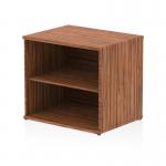 The photo shows a sleek and modern desk high bookcase in walnut finish. The dynamic low design adds a stylish touch to any space. With a depth of 600mm, this bookcase provides ample storage space for books, folders, and other items.