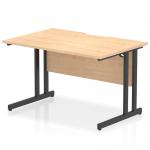 This photo shows a modern office desk with a rectangle shape and scalloped edge. The desk has a maple top and black cantilever legs and measures 1200 x 800mm. It has a dynamic and sleek design, making it a great addition to any professional workspace.