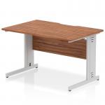 The photo shows a sleek dynamic office desk with a walnut top, silver cable managed legs, and a scalloped edge. The cable management system keeps wires neat and organized. The desk measures 1200 x 800mm and is perfect for modern office spaces.