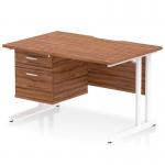 The photograph shows a sleek and modern Dynamic Pedestal Desk Impulse. It features a scalloped edge walnut top, supported by white cantilever legs. The desk also includes a fixed pedestal with 2 drawers for storage. This versatile workstation measures 1200 x 800mm and is ideal for any office space.